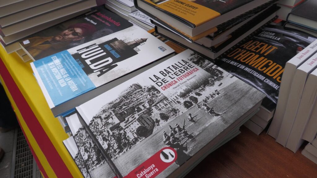 Llibres d'autors ebrencs com Arriembanda i La Batalla de l'Ebre exposats en una parada de Sant Jordi a Tortosa, Terres de l'Ebre.
