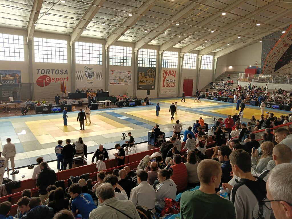 Competició de judo infantil i júnior amb múltiples tatamis i públic al pavelló Jordi Angelats de Tortosa, Terres de l'Ebre.